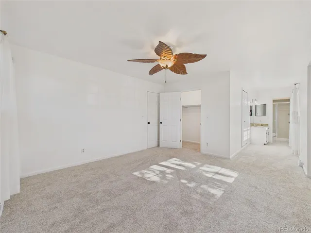 a view of a kitchen with white cabinets