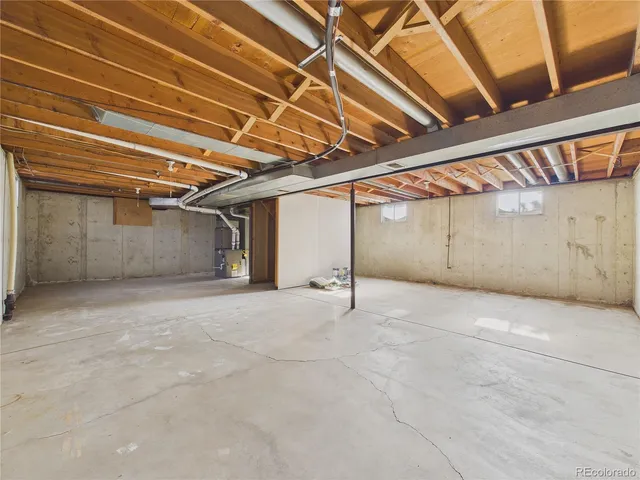 a view of a yard in front of a house with a large tree