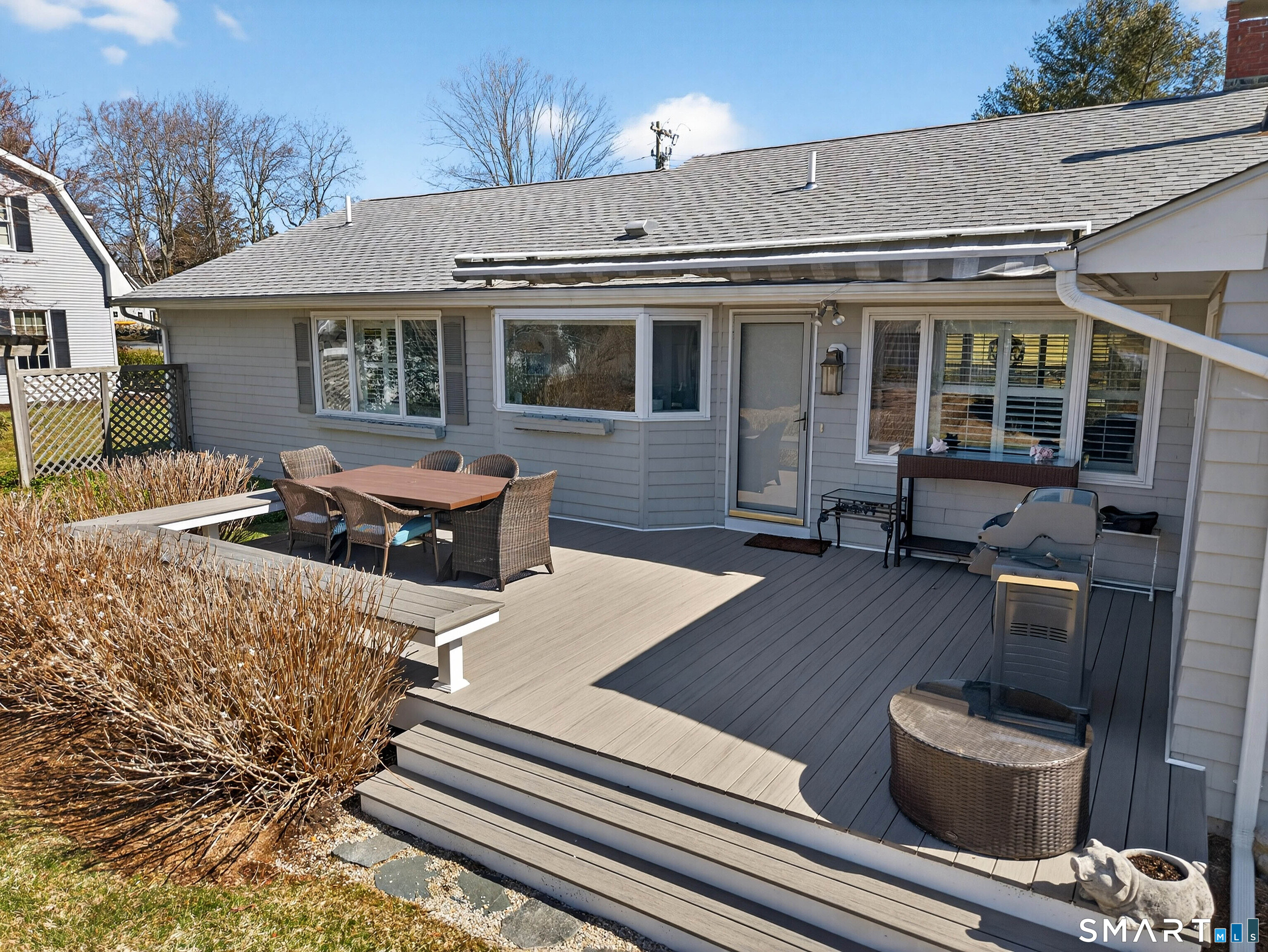 24 Cherry Lane Madison, CT 06443 - Photo 34 of 40 Trex deck and awning off the back of the house