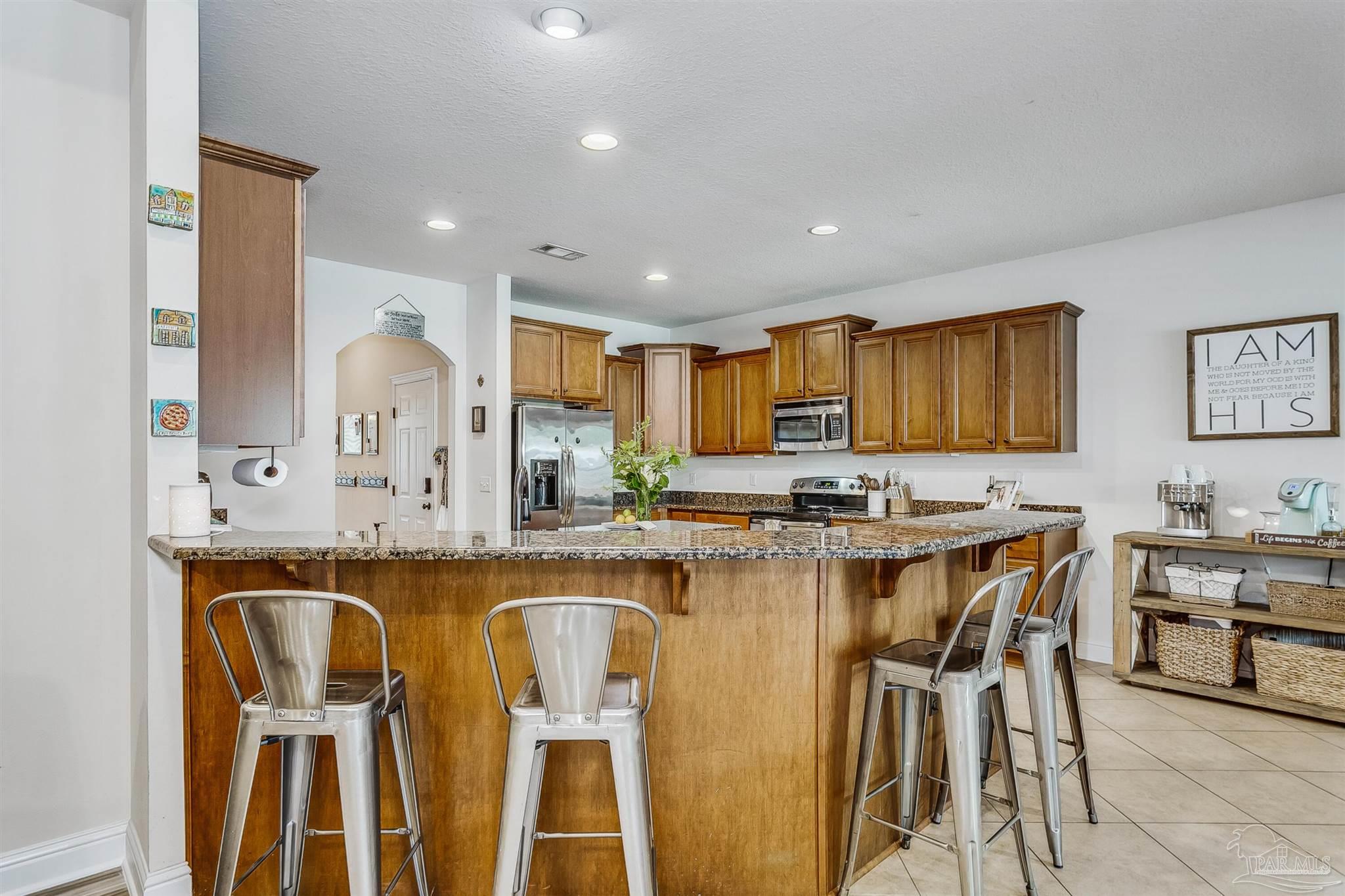 2072 Staff Drive Cantonment, FL 32533 - Photo 13 of 46 a large kitchen with a table and chairs in it
