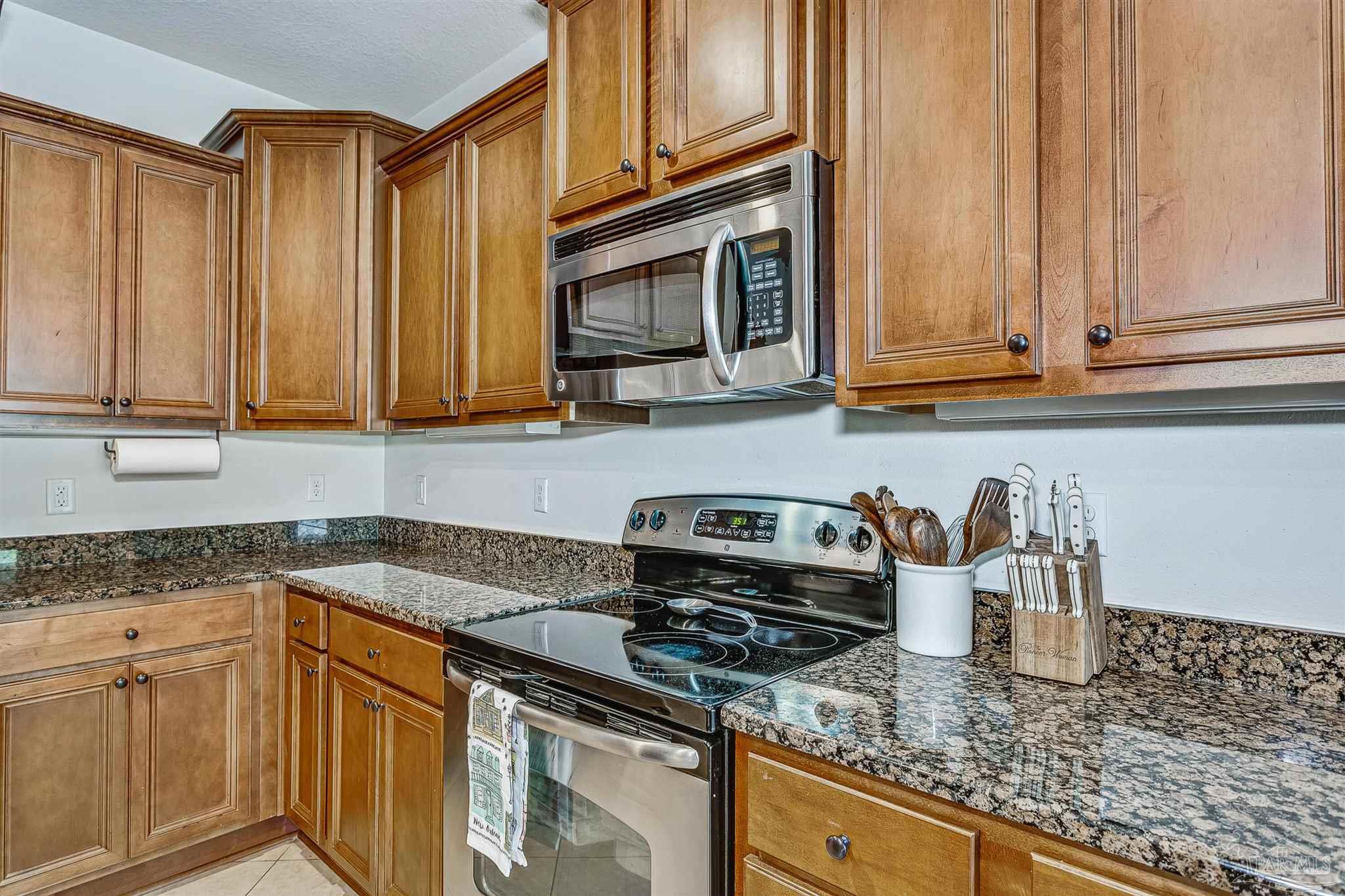 2072 Staff Drive Cantonment, FL 32533 - Photo 17 of 46 a kitchen with stainless steel appliances granite countertop a sink a stove and cabinets