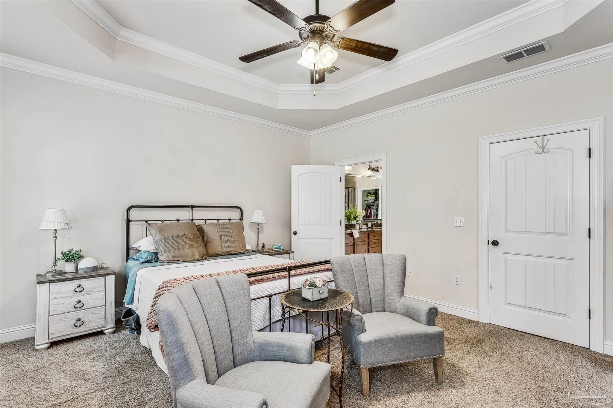 2072 Staff Drive Cantonment, FL 32533 - Photo 22 of 46 a bedroom with a bed and a chandelier