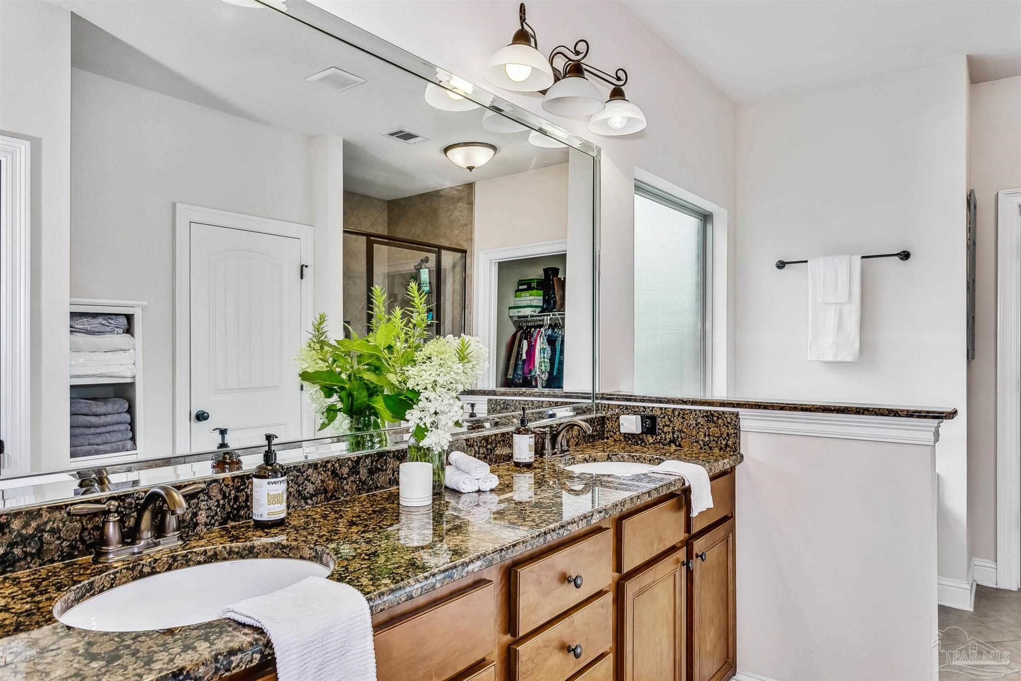 2072 Staff Drive Cantonment, FL 32533 - Photo 24 of 46 a bathroom with a granite countertop sink and a mirror