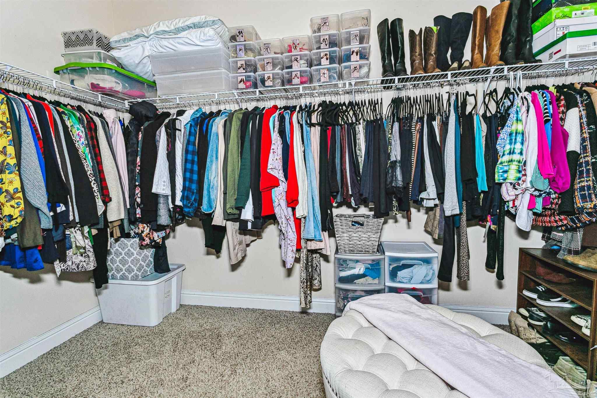 2072 Staff Drive Cantonment, FL 32533 - Photo 27 of 46 a view of walk in closet with clothes and shoes