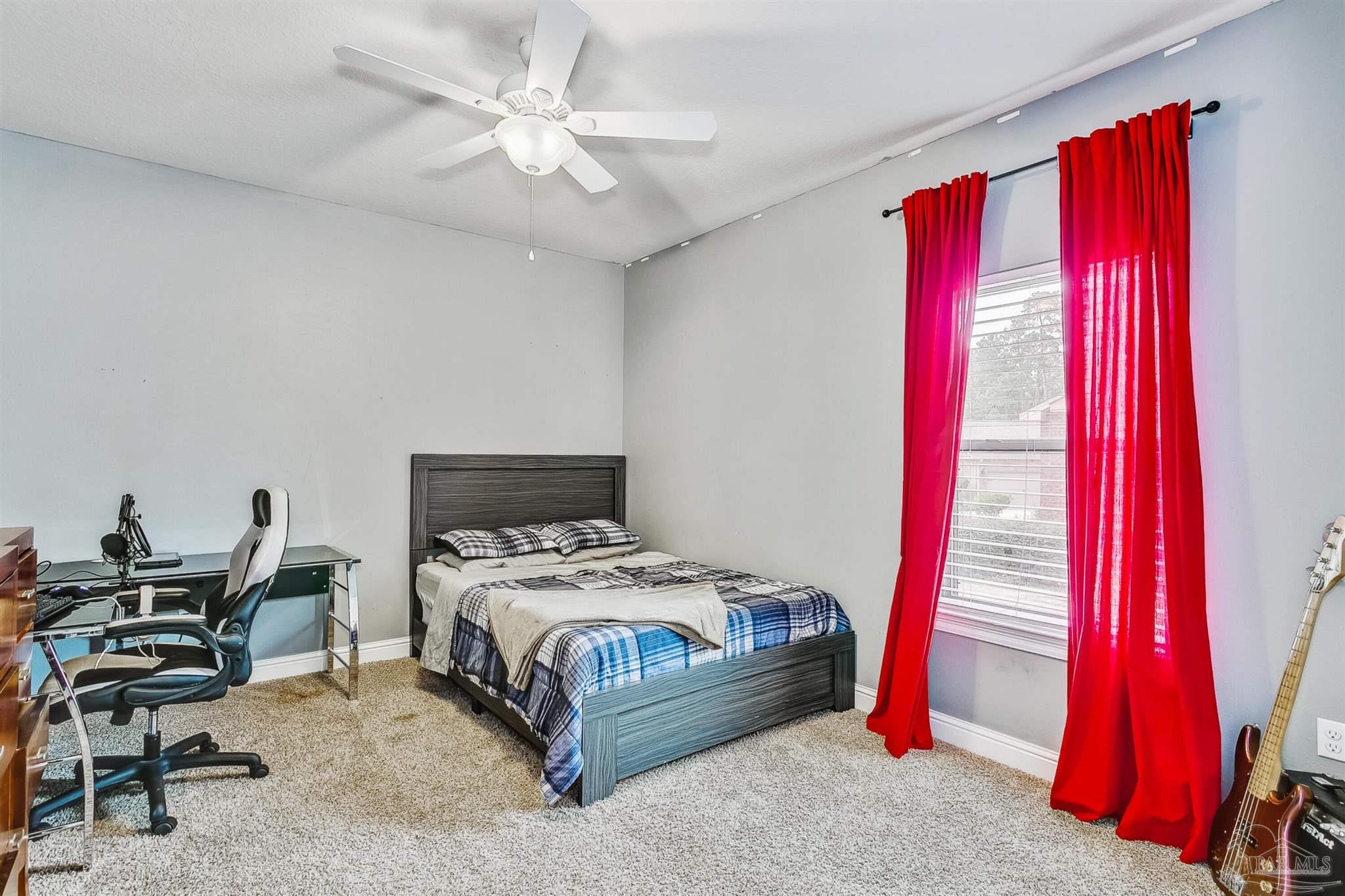 2072 Staff Drive Cantonment, FL 32533 - Photo 30 of 46 a bedroom with a bed and a chandelier