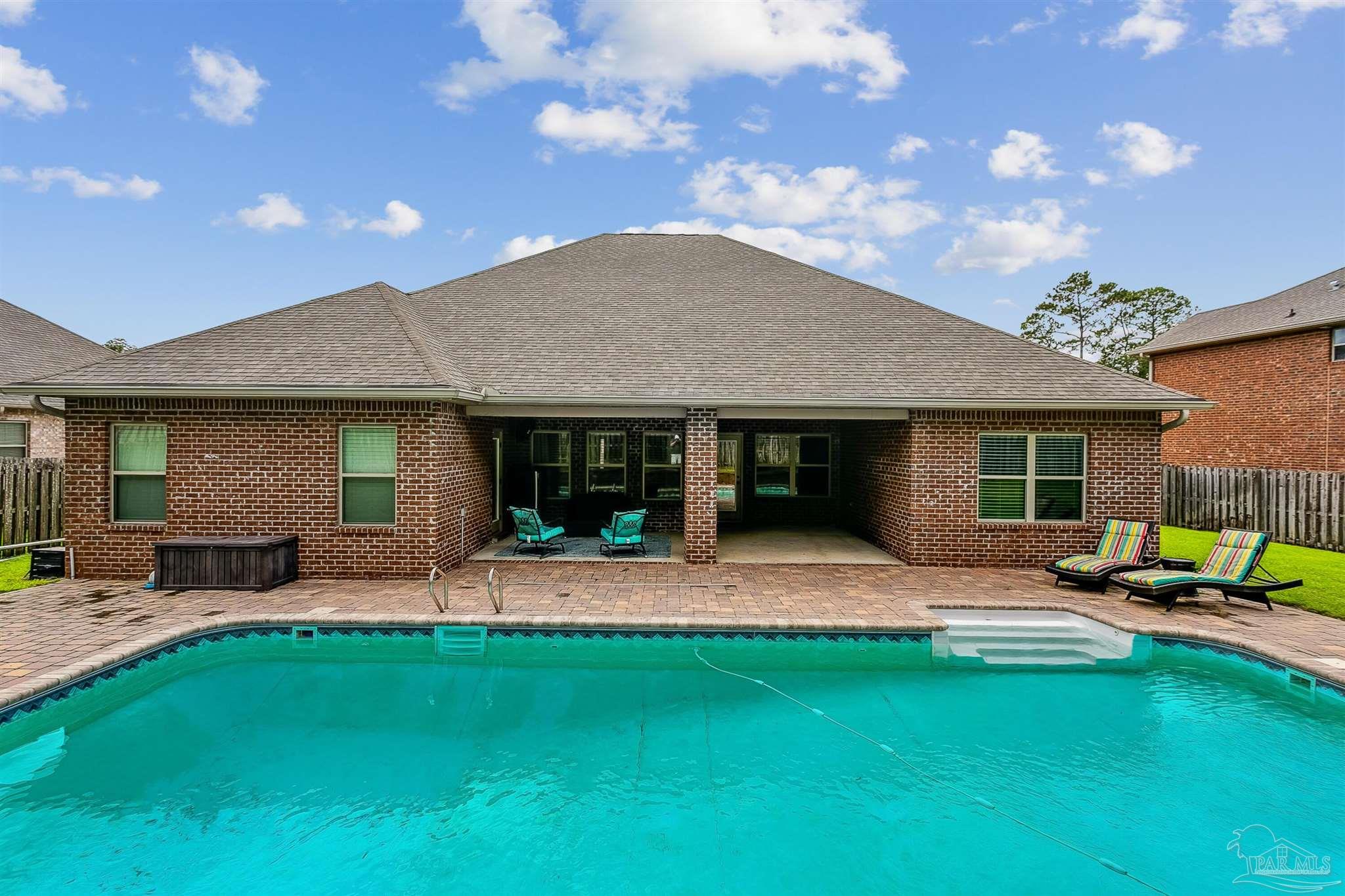2072 Staff Drive Cantonment, FL 32533 - Photo 3 of 46 a patio with a table and chairs and potted plants