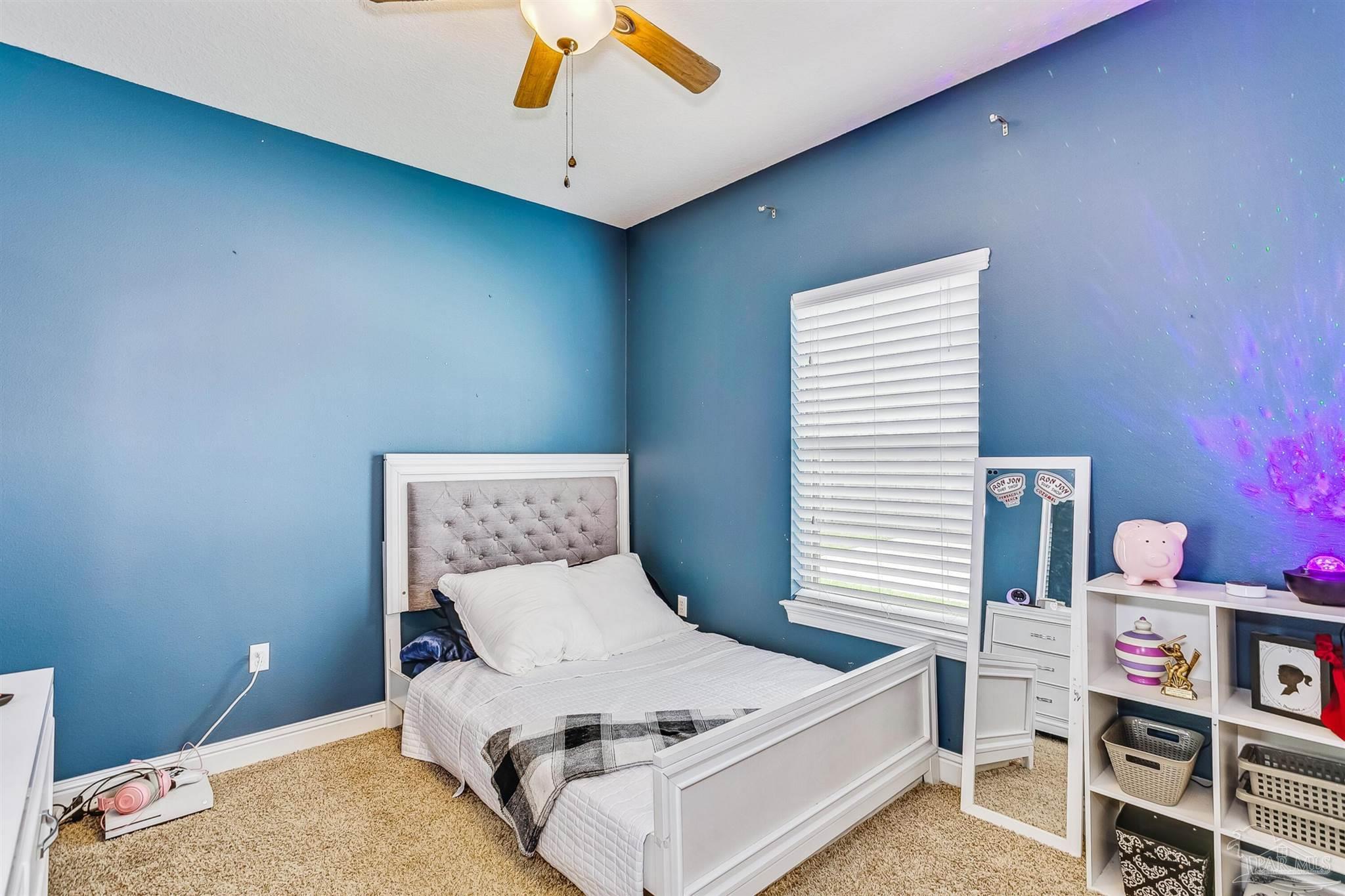 2072 Staff Drive Cantonment, FL 32533 - Photo 31 of 46 a bed room with a bed and a baby crib