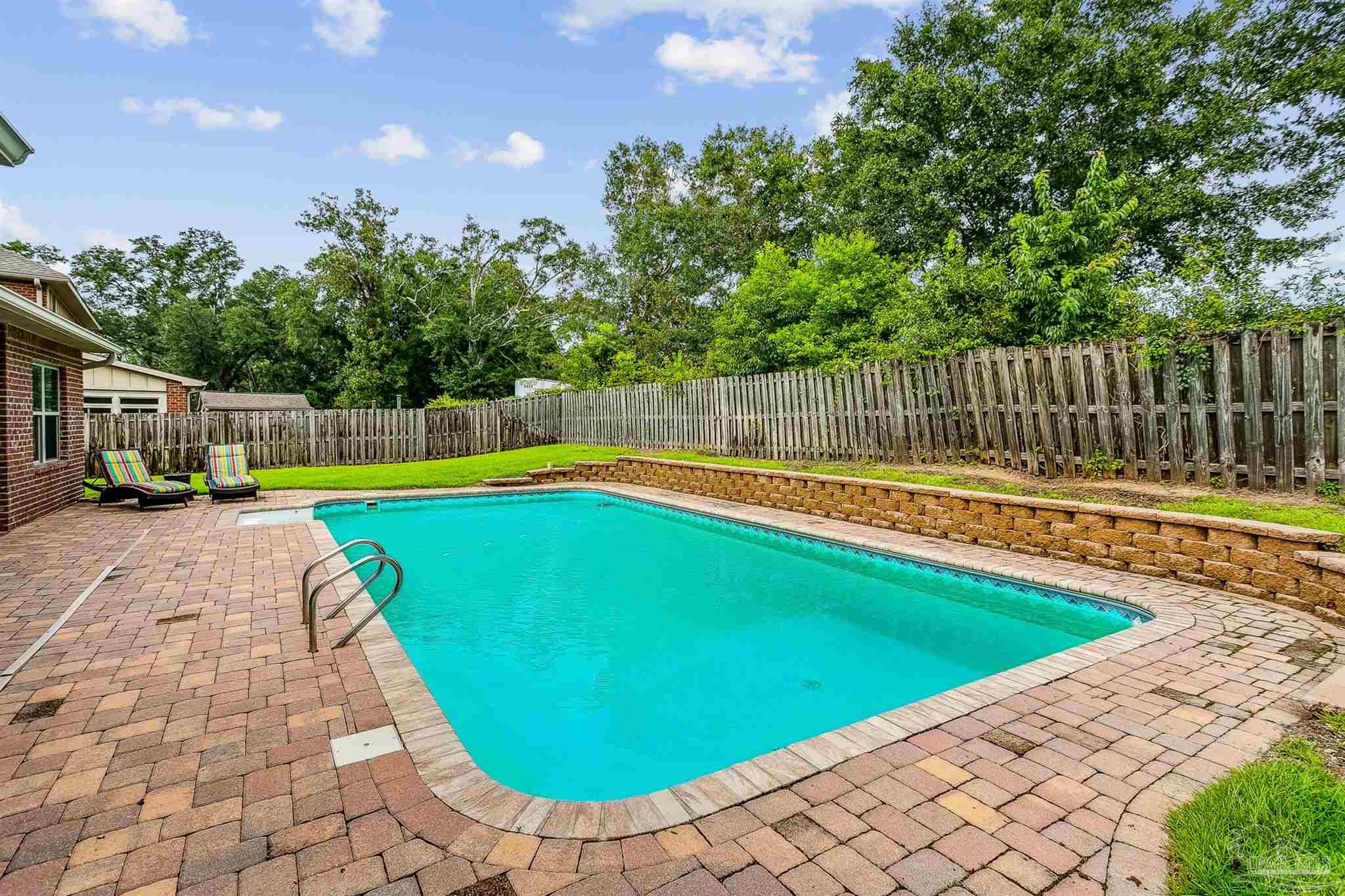 2072 Staff Drive Cantonment, FL 32533 - Photo 38 of 46 a view of swimming pool with a yard and deck