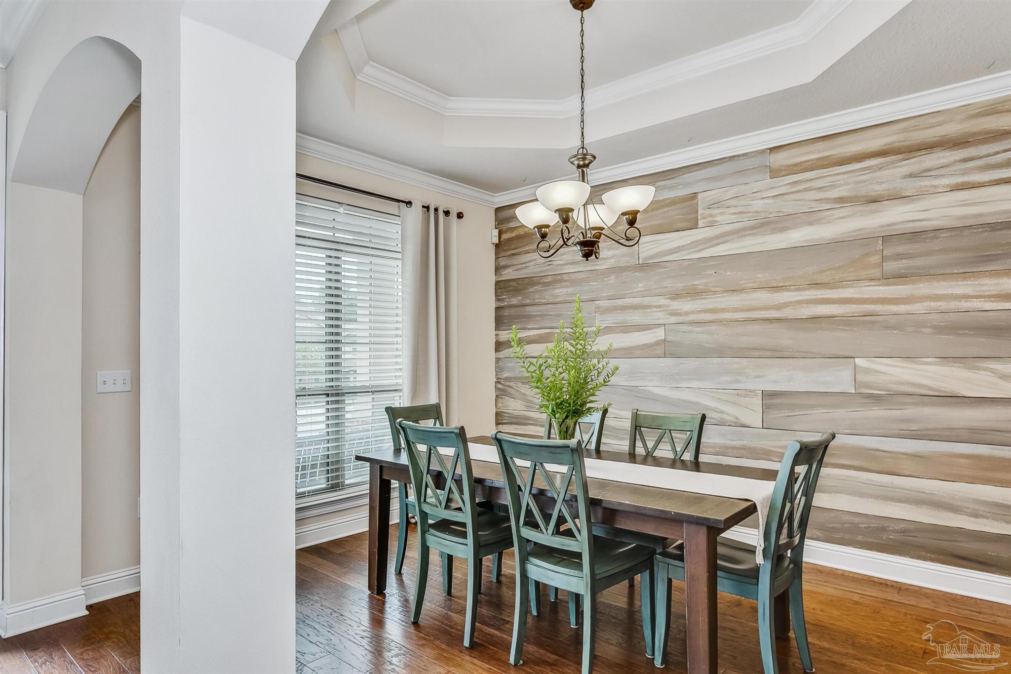 2072 Staff Drive Cantonment, FL 32533 - Photo 6 of 46 a view of a dining room with furniture wooden floor and chandelier