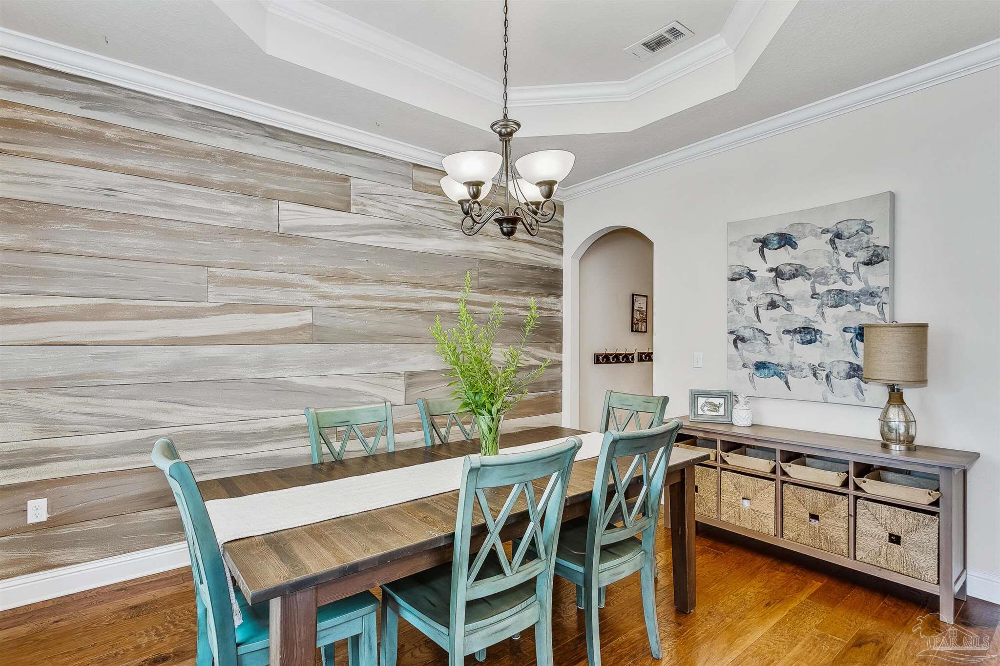 2072 Staff Drive Cantonment, FL 32533 - Photo 7 of 46 a view of a dining room with furniture a chandelier and wooden floor