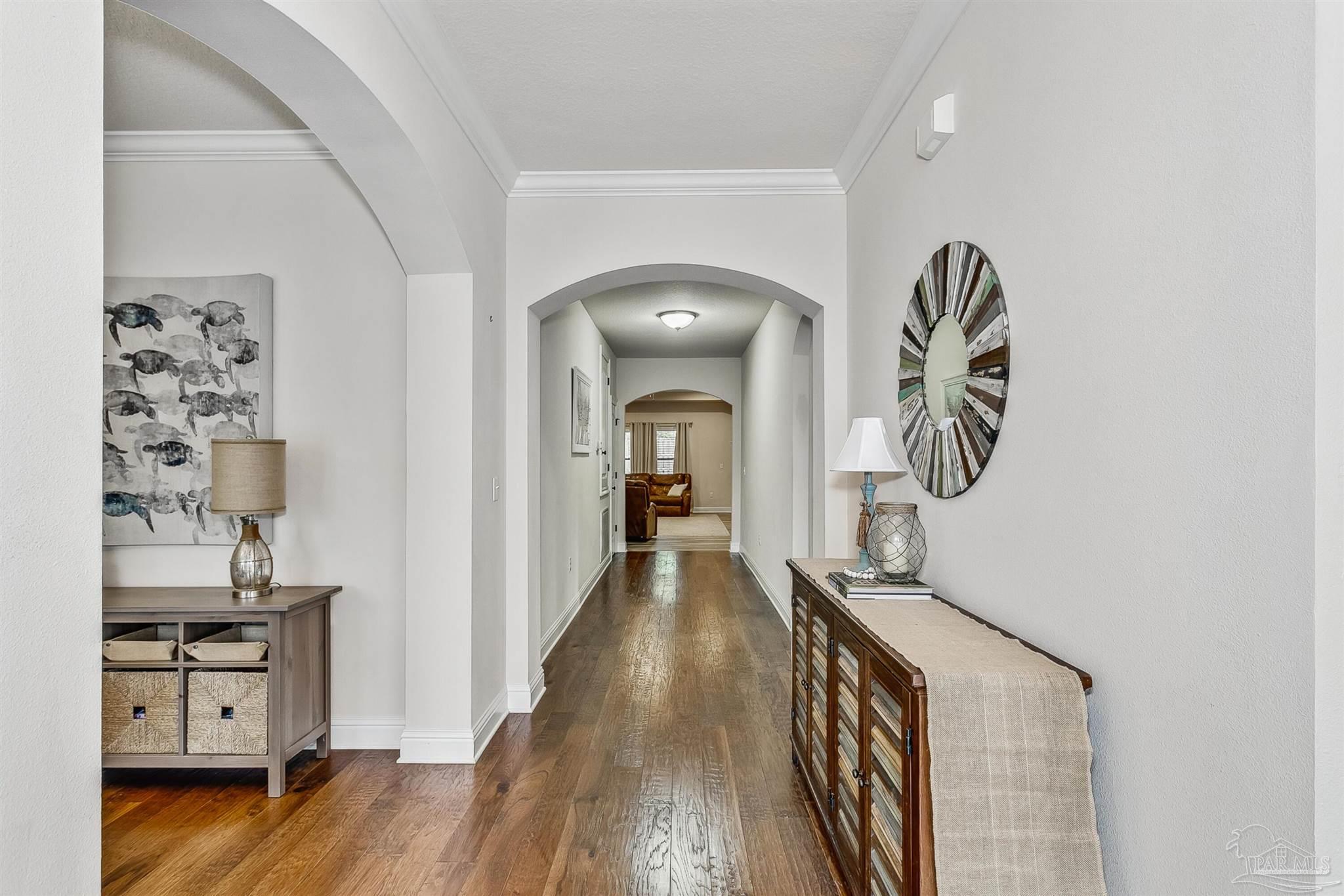 2072 Staff Drive Cantonment, FL 32533 - Photo 8 of 46 a view of a hallway with wooden floor and staircase