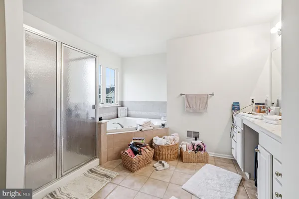 a bathroom with a tub sink and a mirror