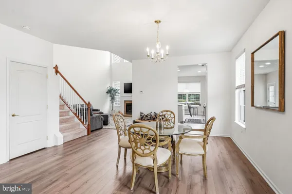 a view of a dining room with furniture wooden floor and chandelier