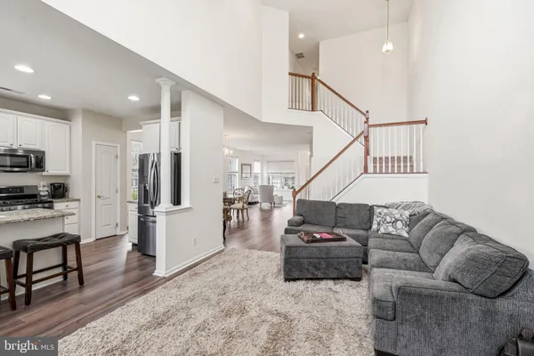 a living room with furniture and kitchen view