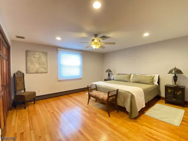 a spacious bedroom with a bed and a chandelier