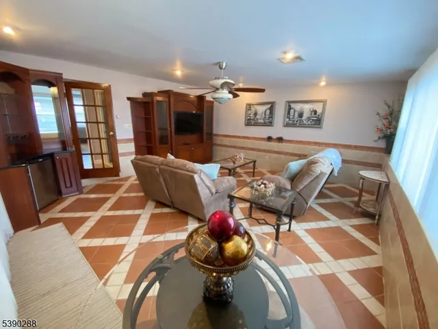 a living room with furniture a flat screen tv and rug floor