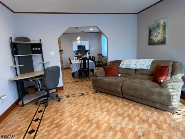 a living room with furniture and a piano