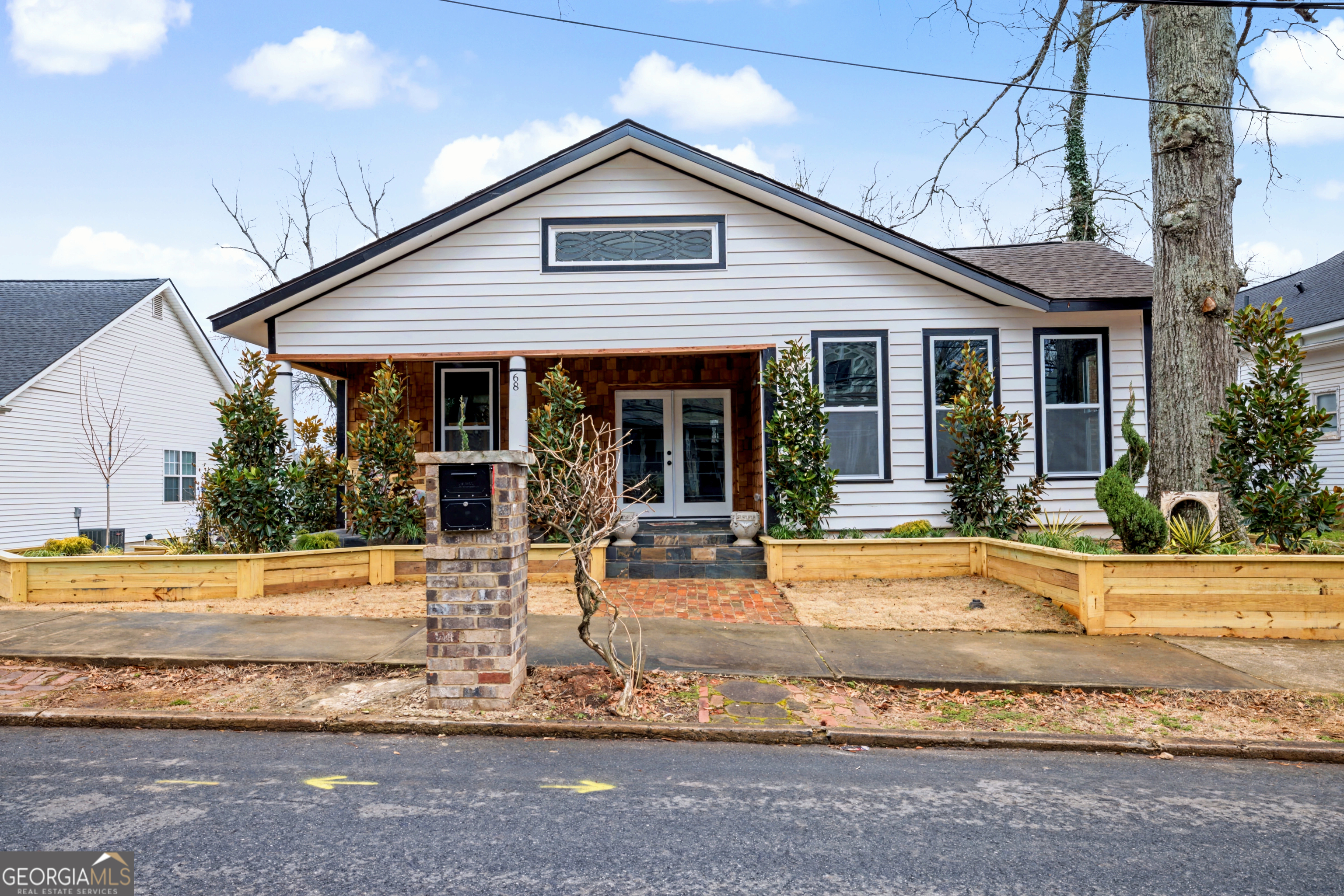a view of a house with backyard porch and sitting area