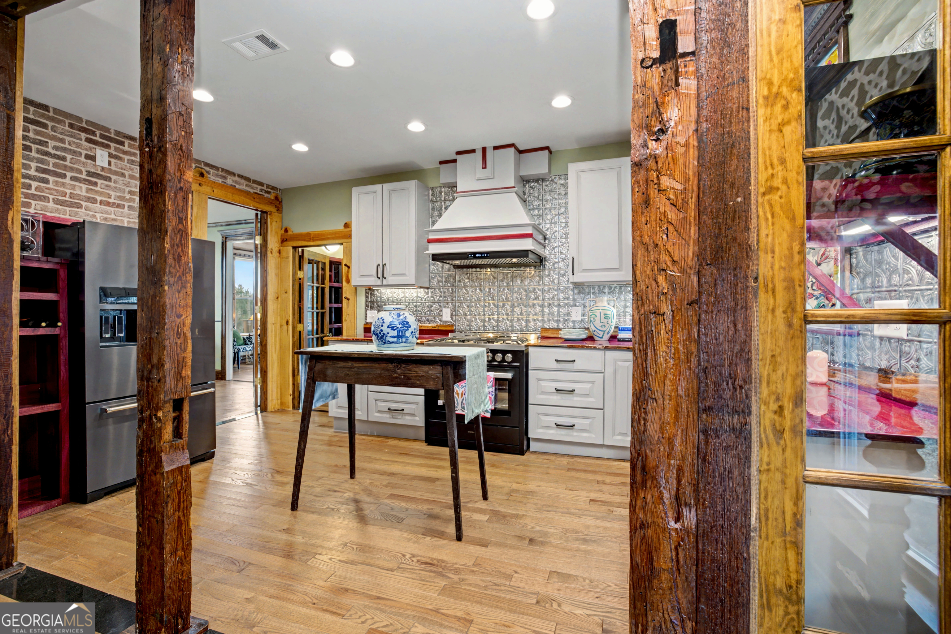 68 Spring Street Newnan, GA 30263 - Photo 16 of 48 a kitchen with stainless steel appliances kitchen island granite countertop a refrigerator and a stove