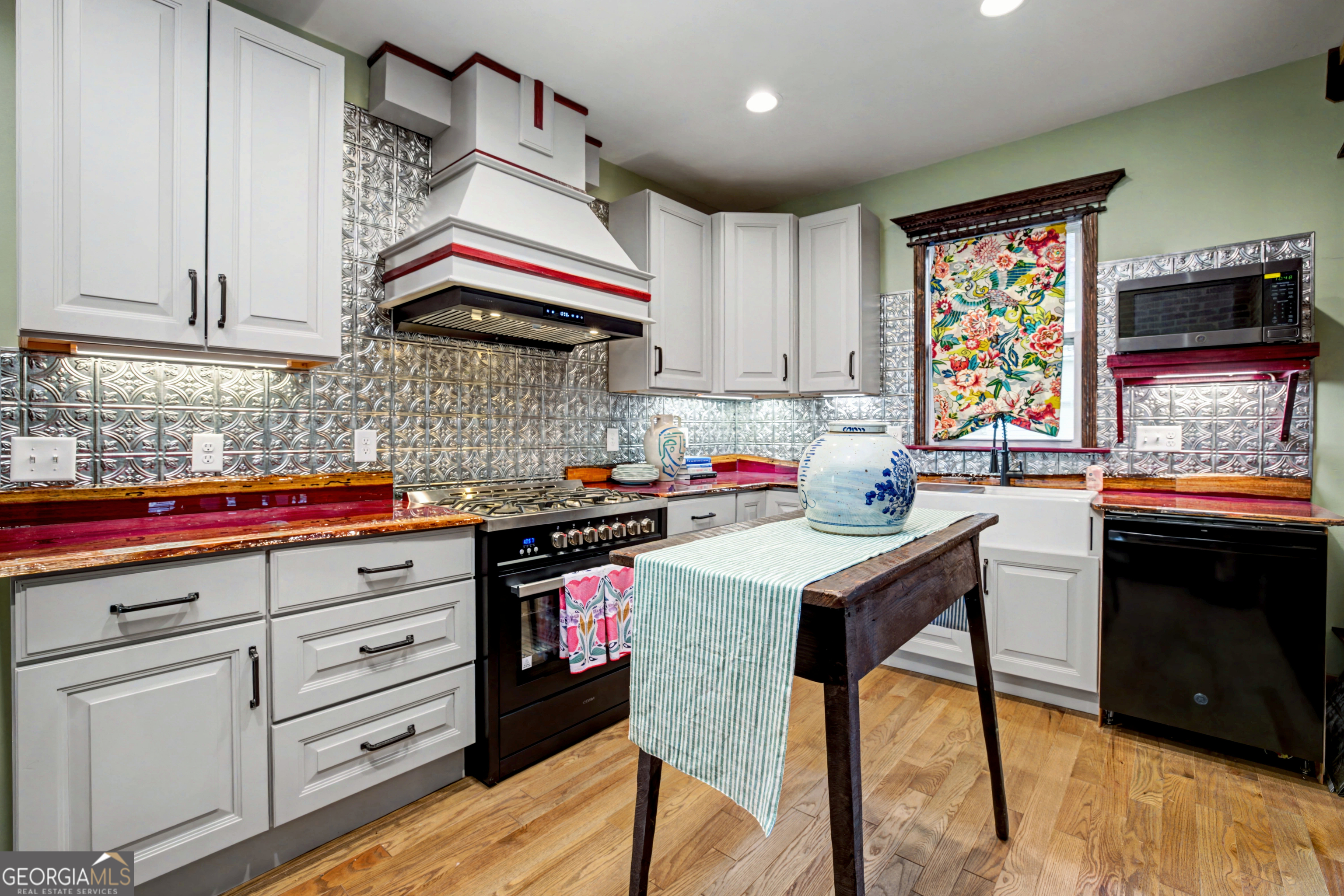 68 Spring Street Newnan, GA 30263 - Photo 18 of 48 a kitchen with stainless steel appliances granite countertop a stove and cabinets