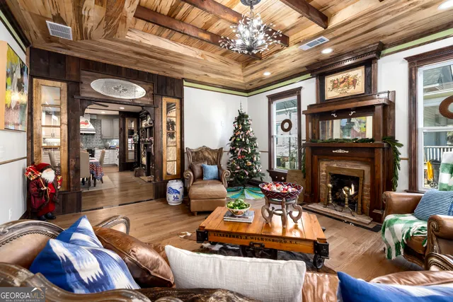 a living room with furniture a window and a flat screen tv