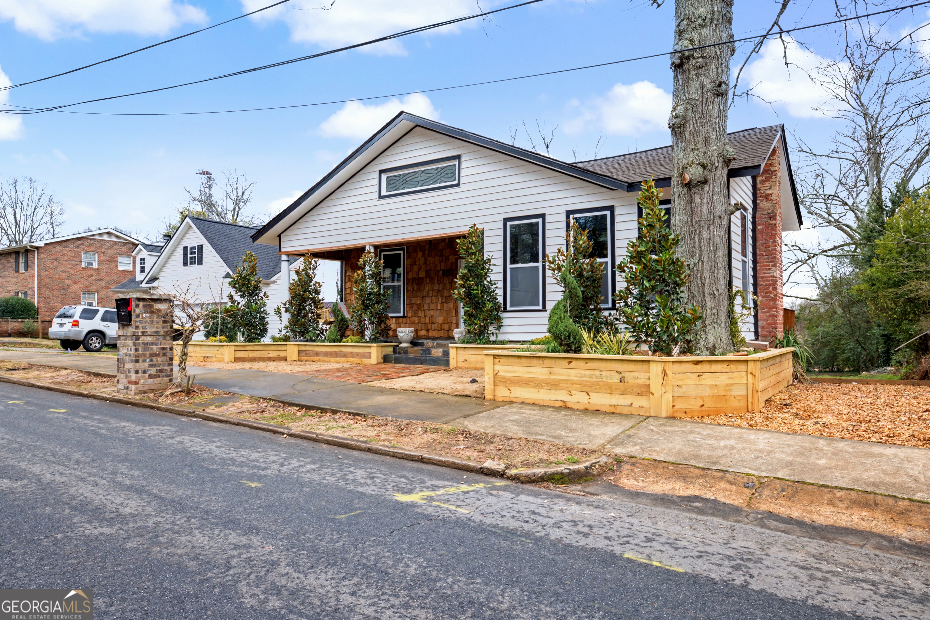 68 Spring Street Newnan, GA 30263 - Photo 2 of 48 a view of a house with cars park