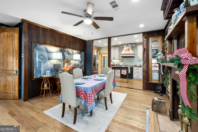 a living room with furniture a fireplace and a chandelier