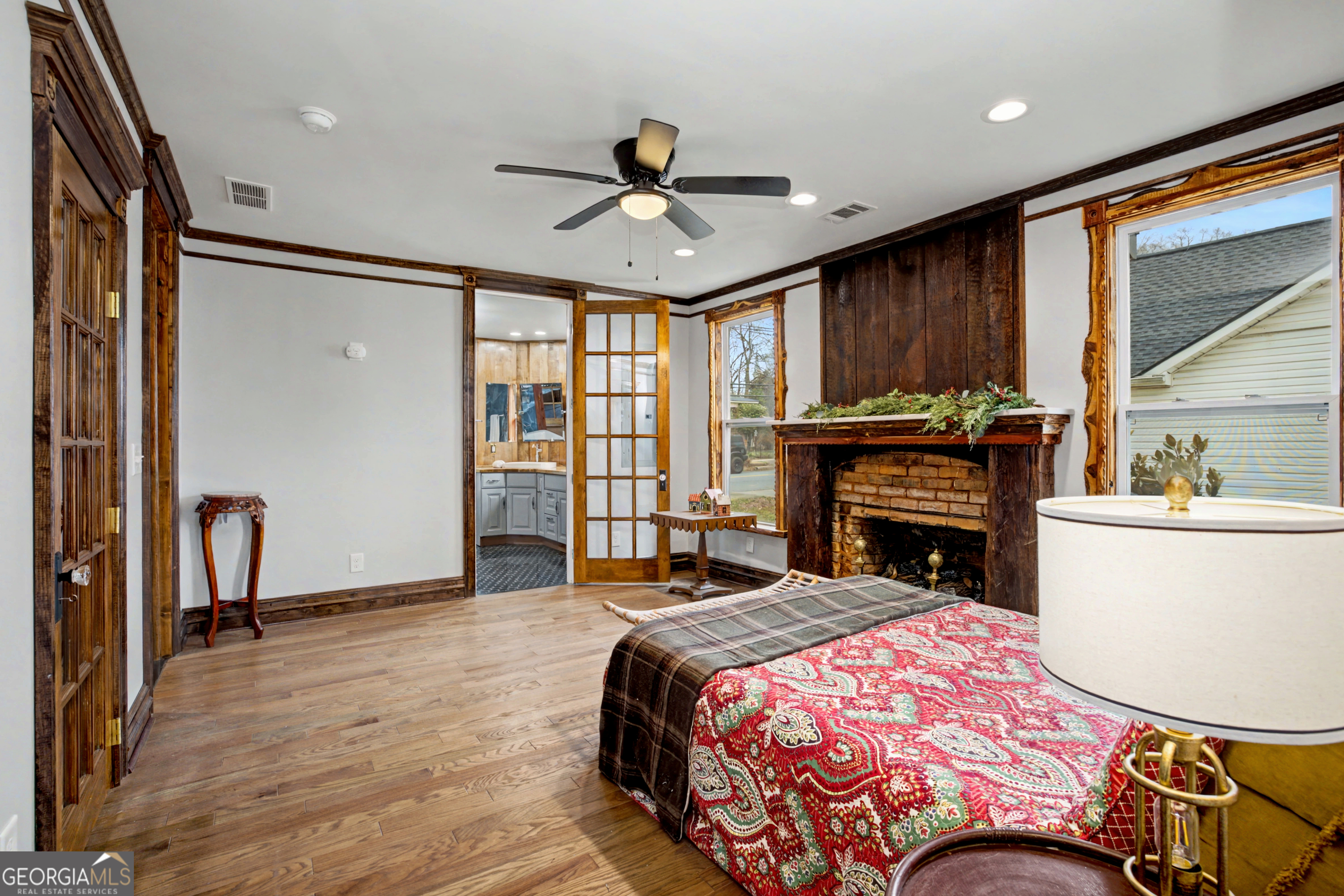 68 Spring Street Newnan, GA 30263 - Photo 27 of 48 a bedroom with a bed and a chandelier