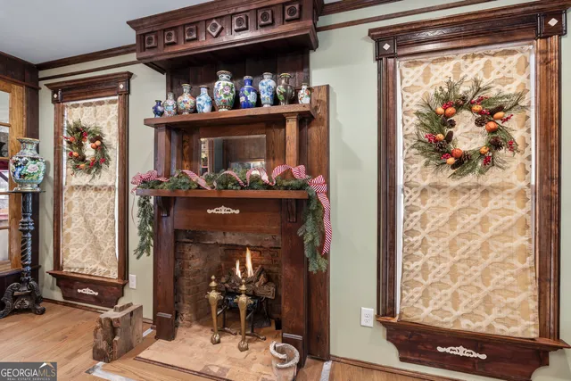 a living room with furniture a wooden floor and next to a window