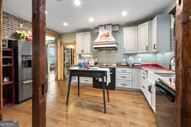 a kitchen with a stove a sink and cabinets