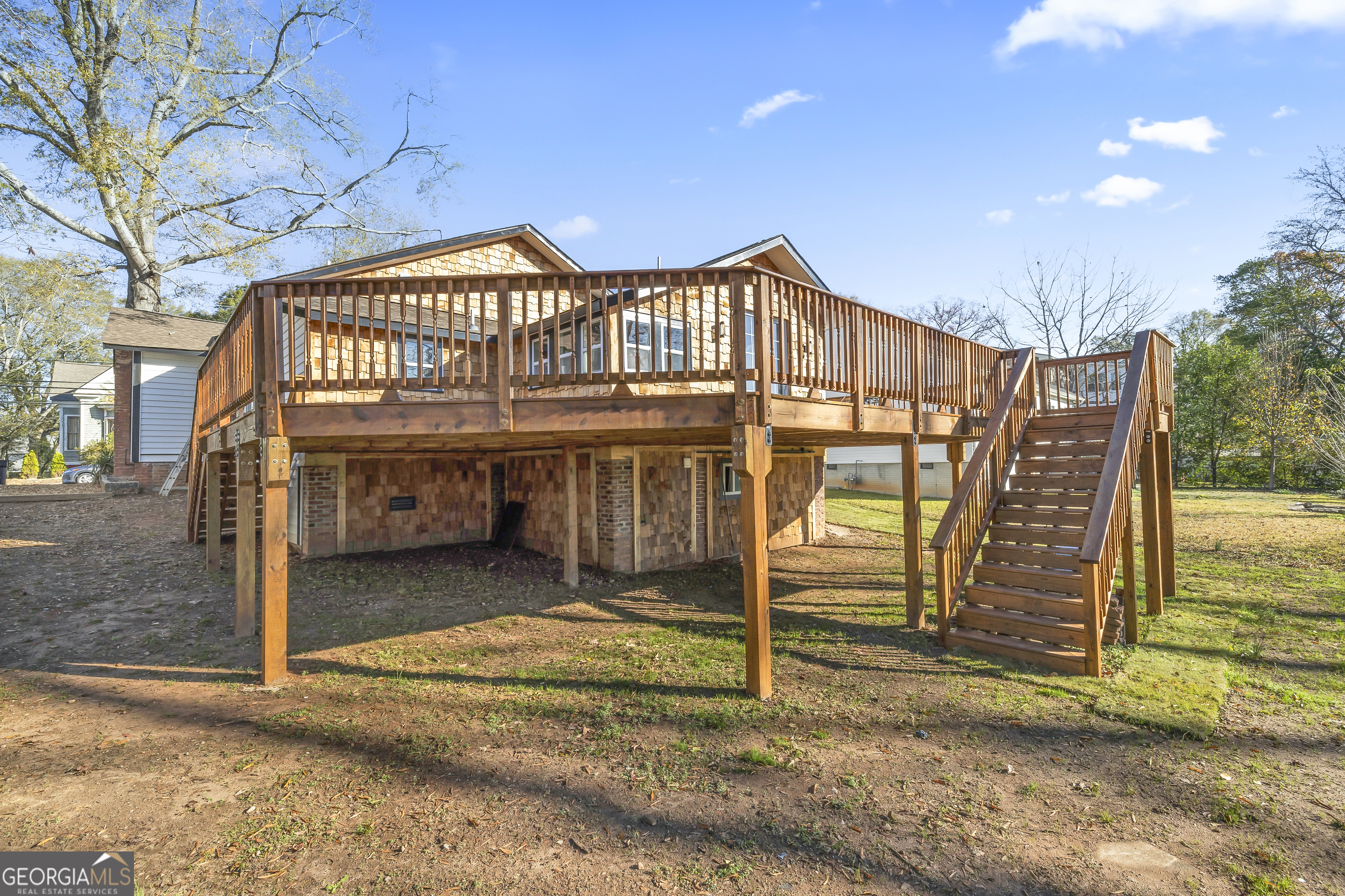 68 Spring Street Newnan, GA 30263 - Photo 36 of 48 a view of a house with a wooden deck