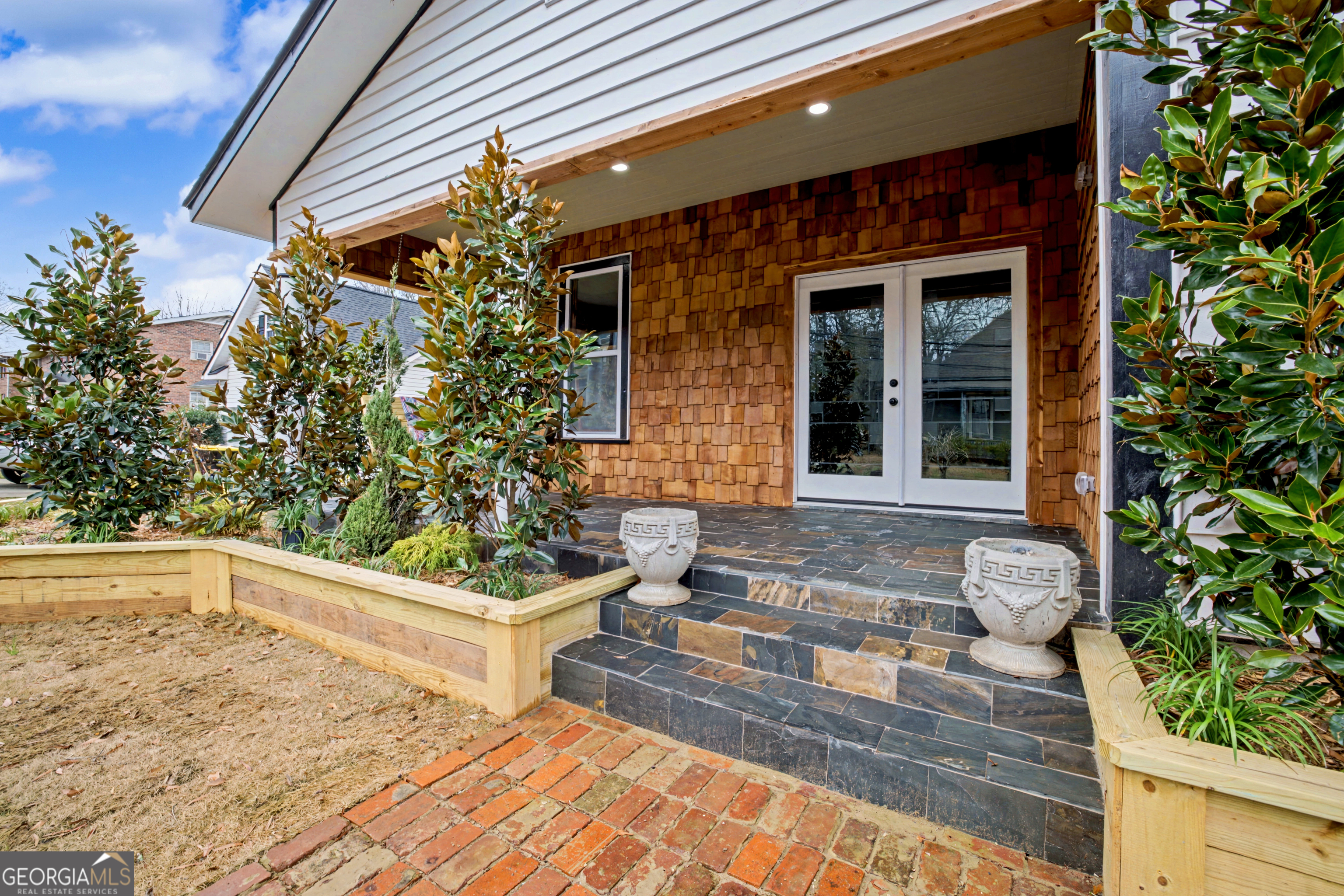 68 Spring Street Newnan, GA 30263 - Photo 4 of 48 a view of brick house with potted plants