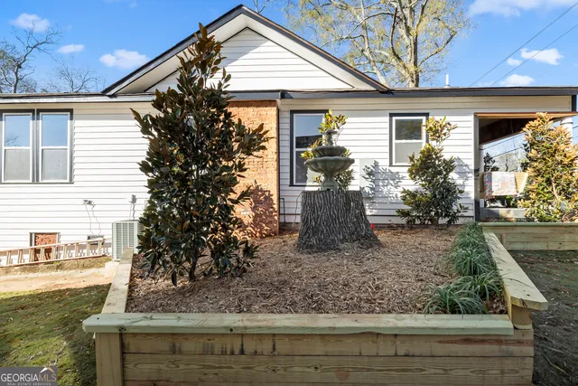 a front view of a house with garden