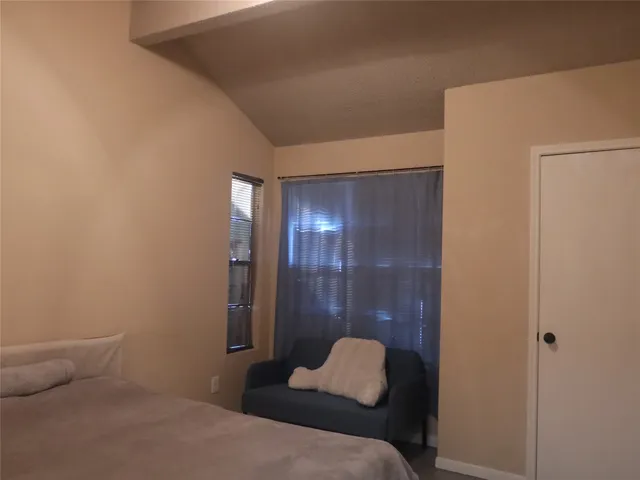 a bedroom with a bed and a lamp