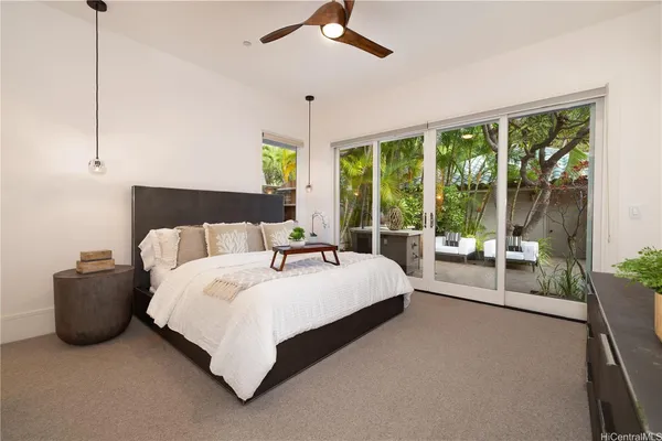 a bed room with a bed and a large window