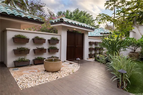 a front view of a house with garden