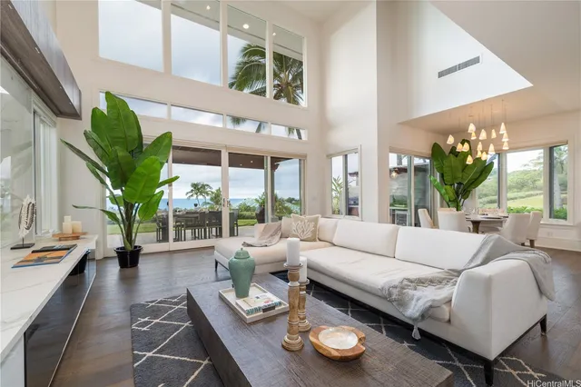 a living room with furniture and a large window with garden view