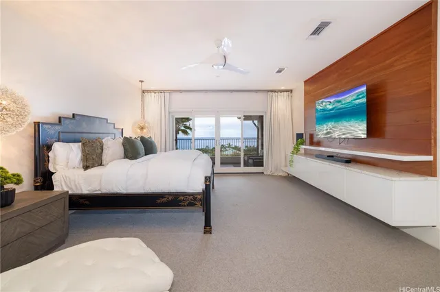 a bedroom with bed and large window