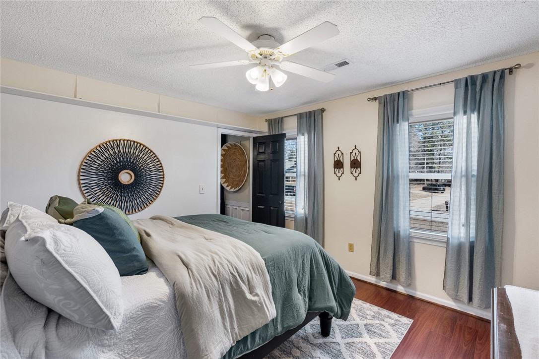 112 C-10-220 Anderson, SC 29621 - Photo 32 of 45 This cozy bedroom features warm wood flooring and ample natural light.