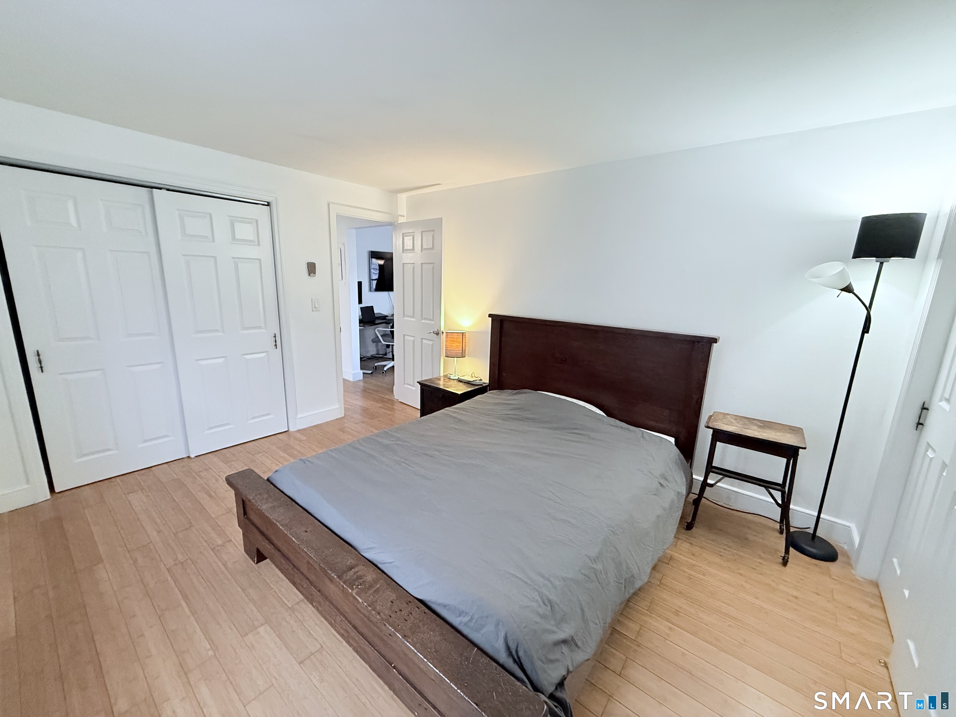 8 Wardwell Street, Unit 5 Stamford, CT 06902 - Photo 8 of 13 a bedroom with a bed and wooden floor