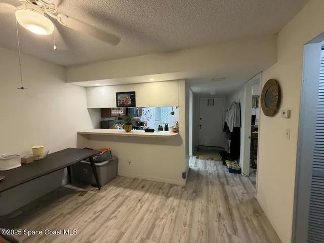 a kitchen with a sink and wooden floor