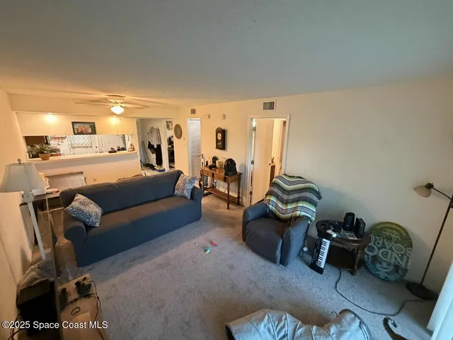 a living room with furniture and a gym machine