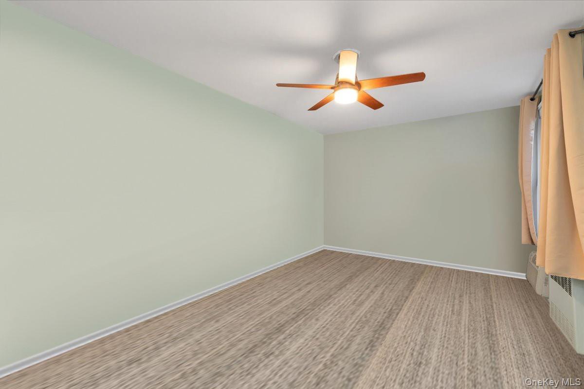 80-35 Springfield Boulevard, Unit 4F Queens, NY 11427 - Photo 11 of 24 Spare room featuring baseboards and a ceiling fan