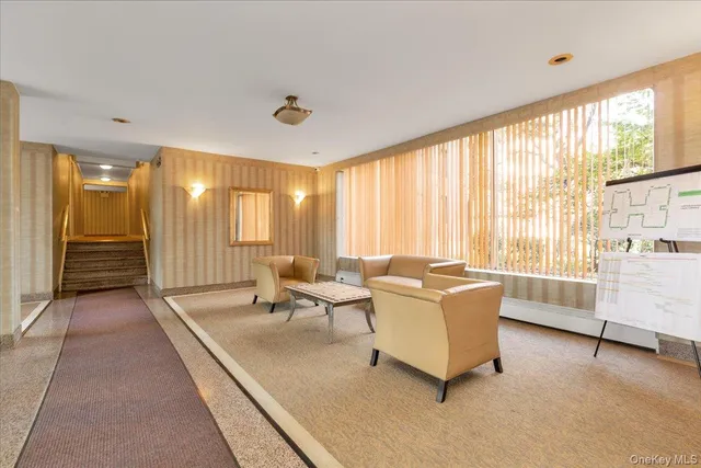 a living room with furniture and large windows