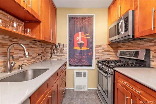 a kitchen with stainless steel appliances granite countertop a stove and a sink