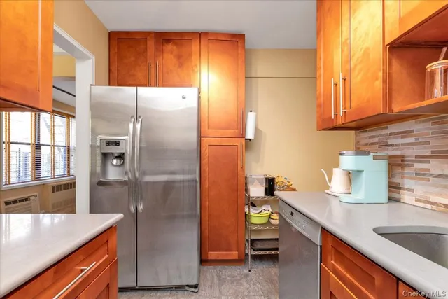 a kitchen with stainless steel appliances granite countertop a refrigerator and a sink