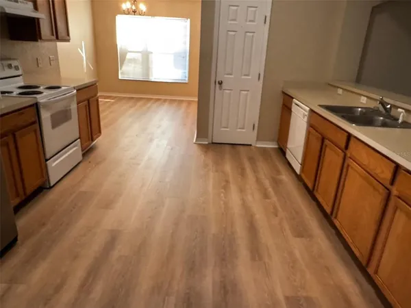 a view of a kitchen from the hallway