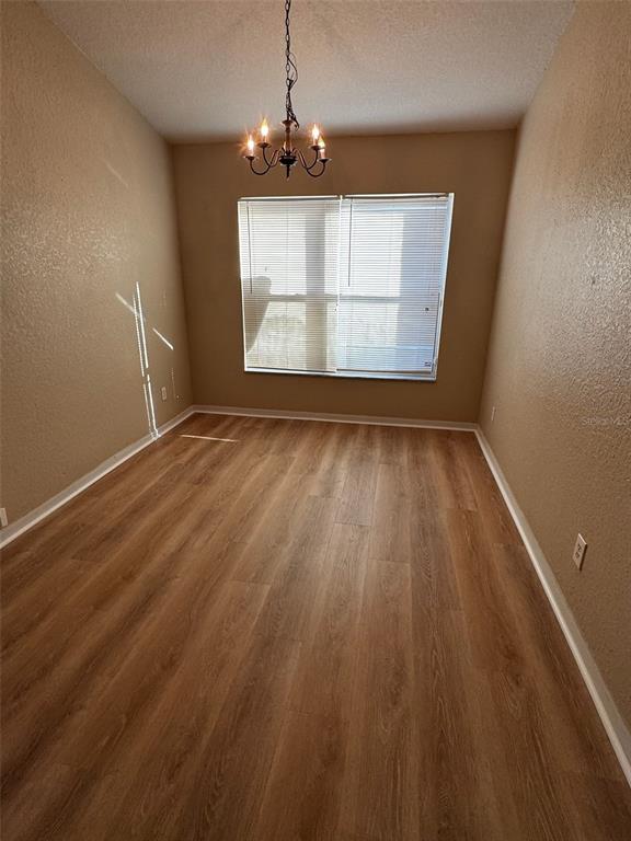 2702 Rochelle Drive Winter Haven, FL 33881 - Photo 5 of 11 wooden floor in an empty room with a window