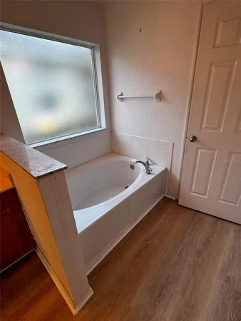 a view of a room with wooden floor and white walls