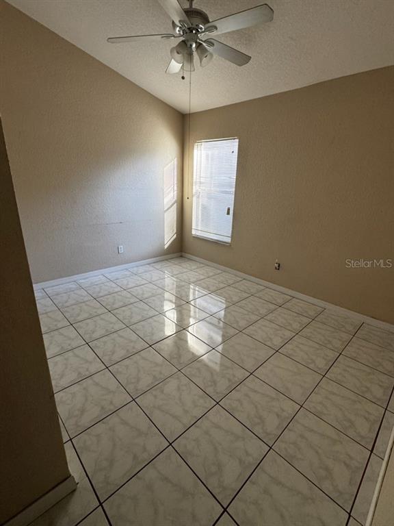 2702 Rochelle Drive Winter Haven, FL 33881 - Photo 10 of 11 an empty room with windows and fan